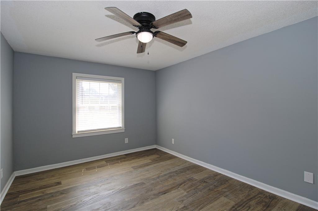 122 Rue Fontaine Lithonia, GA 30038 - Photo 29 of 36 an empty room with wooden floor and windows
