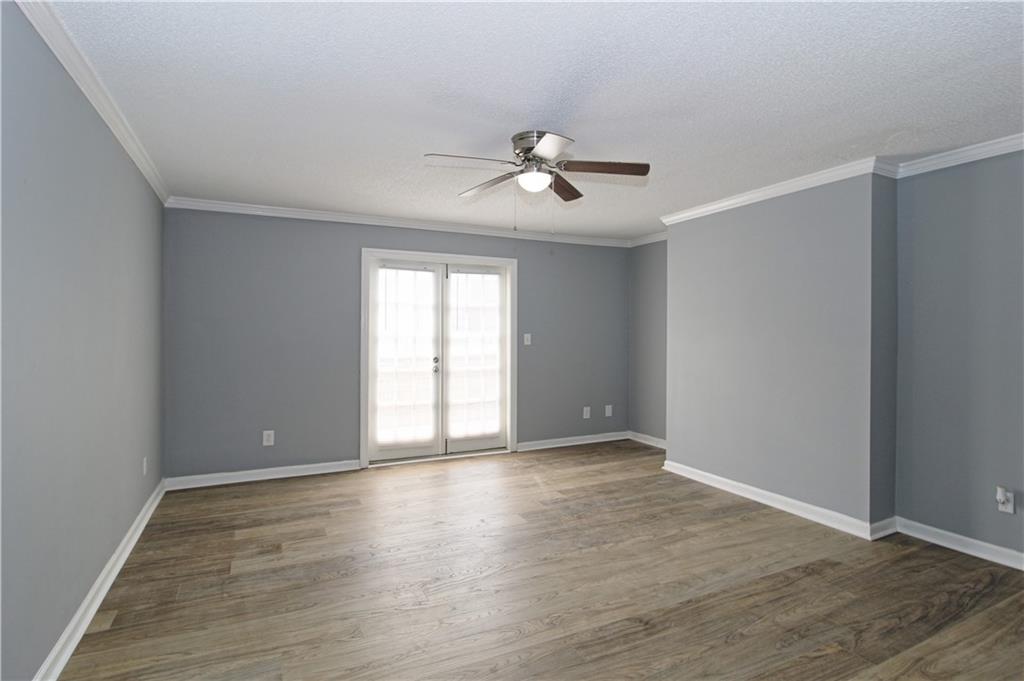 122 Rue Fontaine Lithonia, GA 30038 - Photo 3 of 36 a view of an empty room with wooden floor and a window