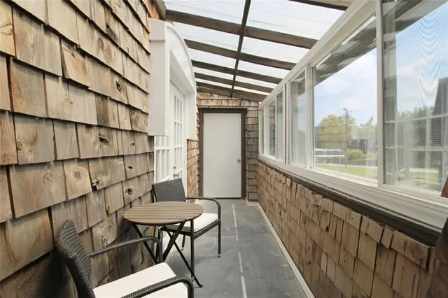 a view of a balcony with furniture and a gate