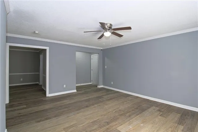 a view of empty room with wooden floor