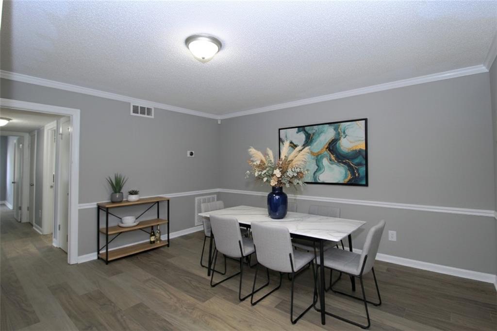 122 Rue Fontaine Lithonia, GA 30038 - Photo 5 of 36 a view of a dining room with furniture and wooden floor