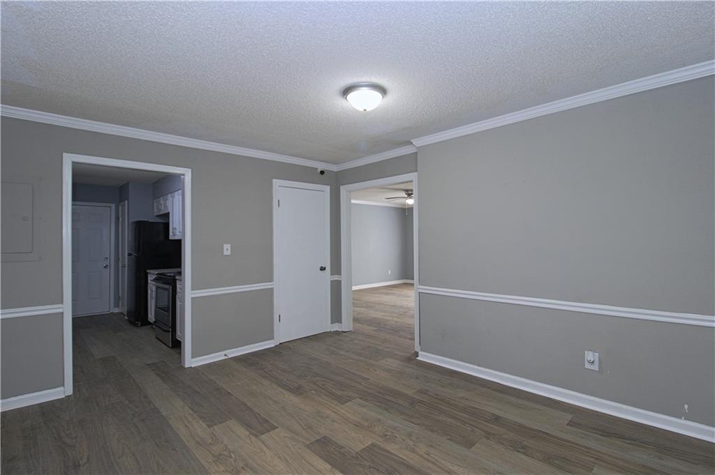 122 Rue Fontaine Lithonia, GA 30038 - Photo 8 of 36 wooden floor in an empty room with a window