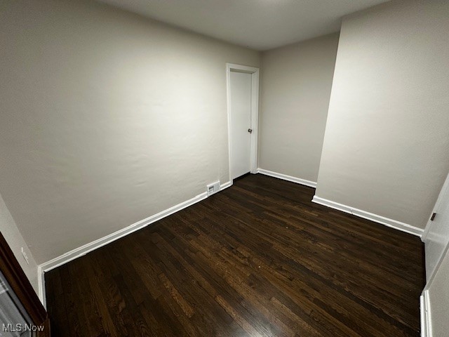 10488 Dewhurst Road Elyria, OH 44035 - Photo 18 of 22 Empty room with baseboards and dark wood-type flooring