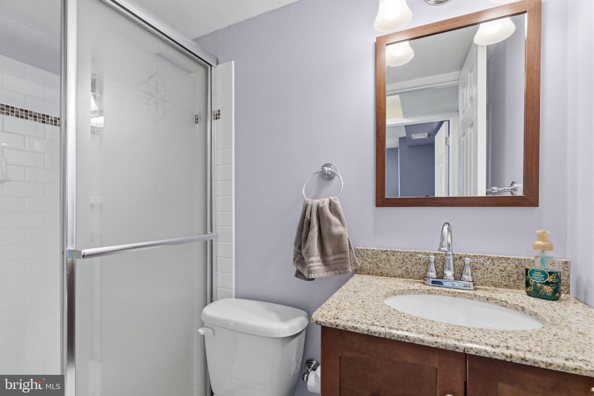 502 Stevens Road Morrisville, PA 19067 - Photo 20 of 37 a bathroom with a granite countertop sink toilet and mirror