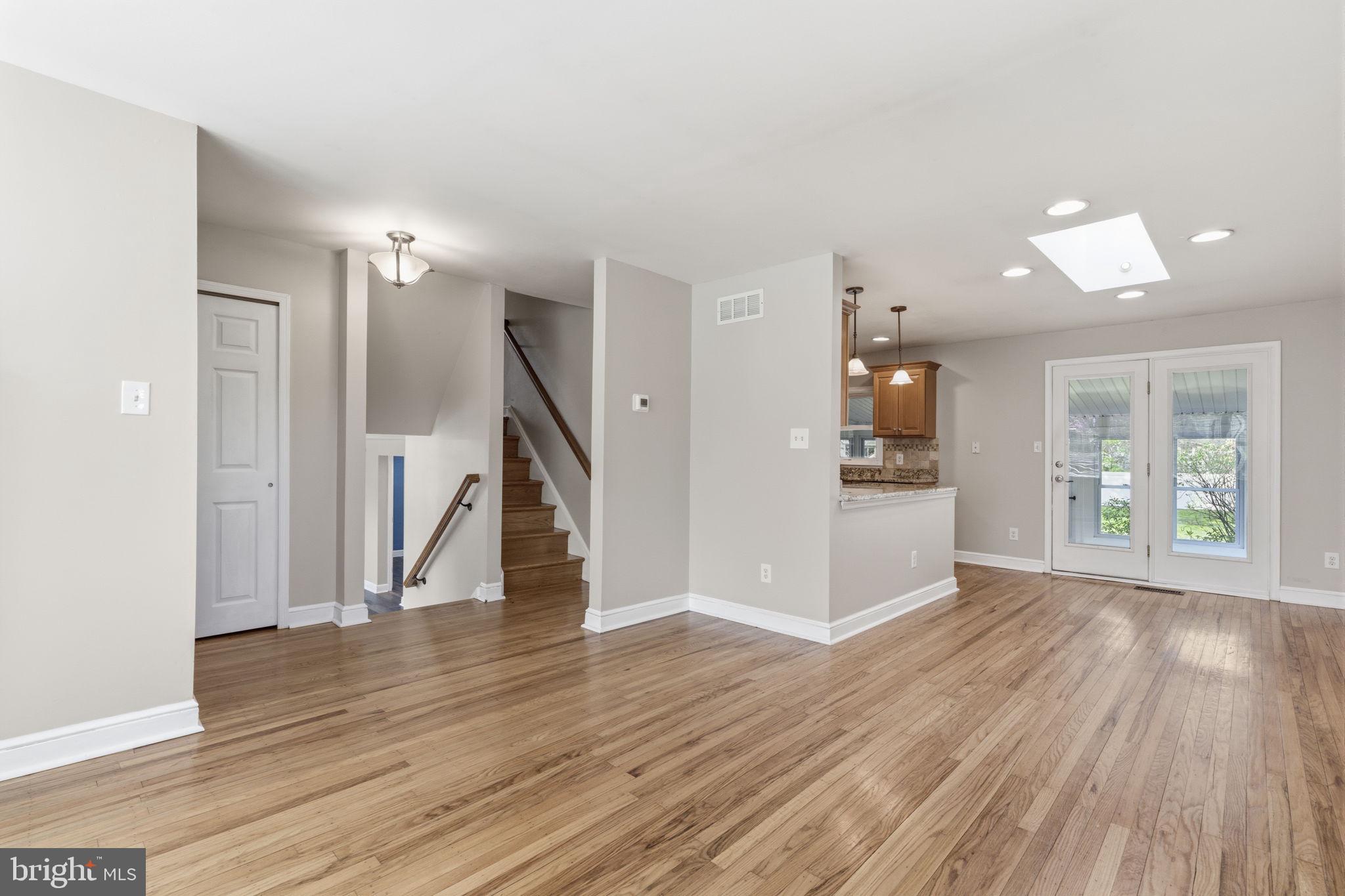 502 Stevens Road Morrisville, PA 19067 - Photo 7 of 37 a view of empty room with wooden floor and kitchen