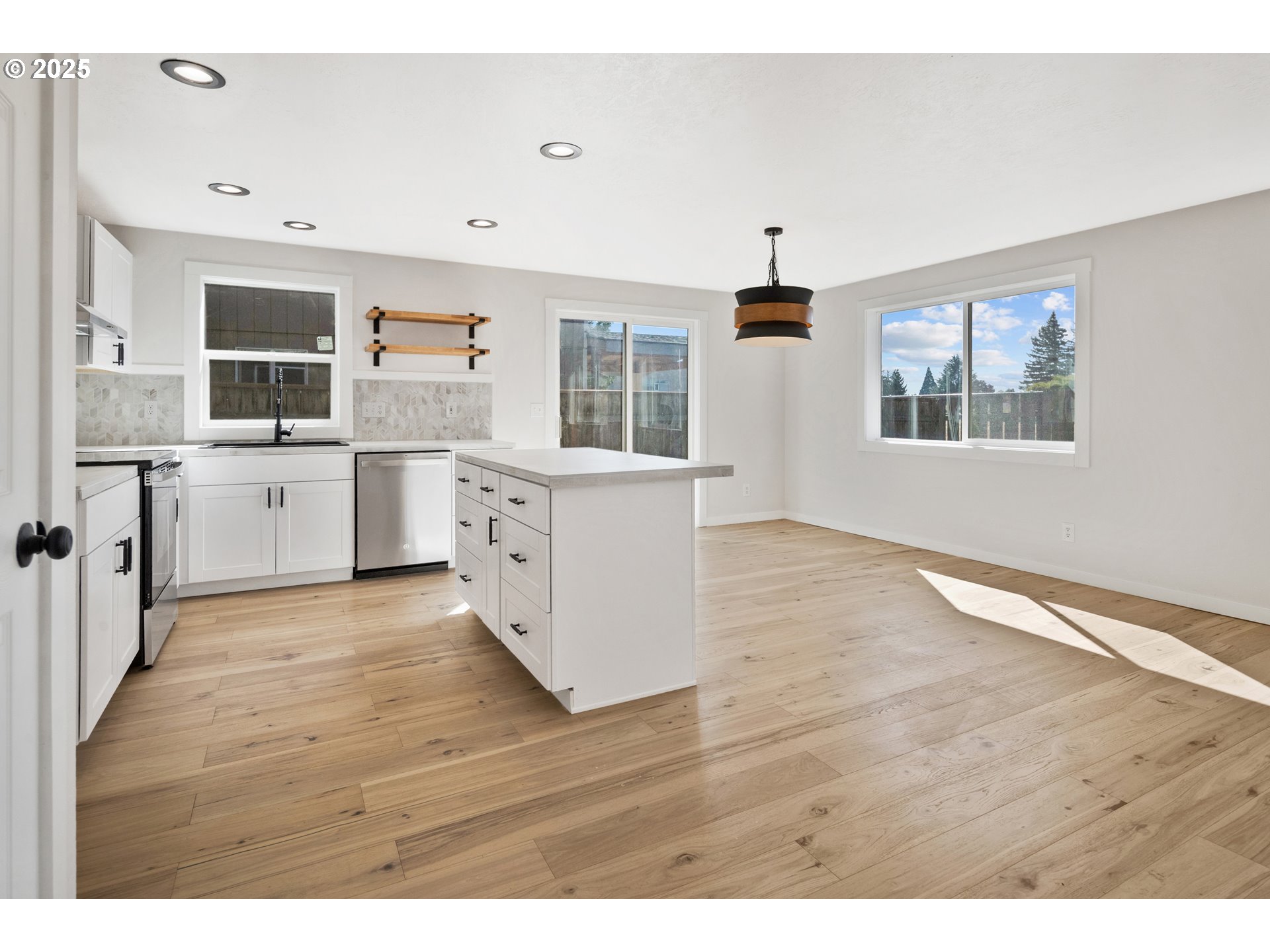 169 South 25th Avenue Cornelius, OR 97113 - Photo 7 of 27 a open kitchen with cabinets stove and wooden floor