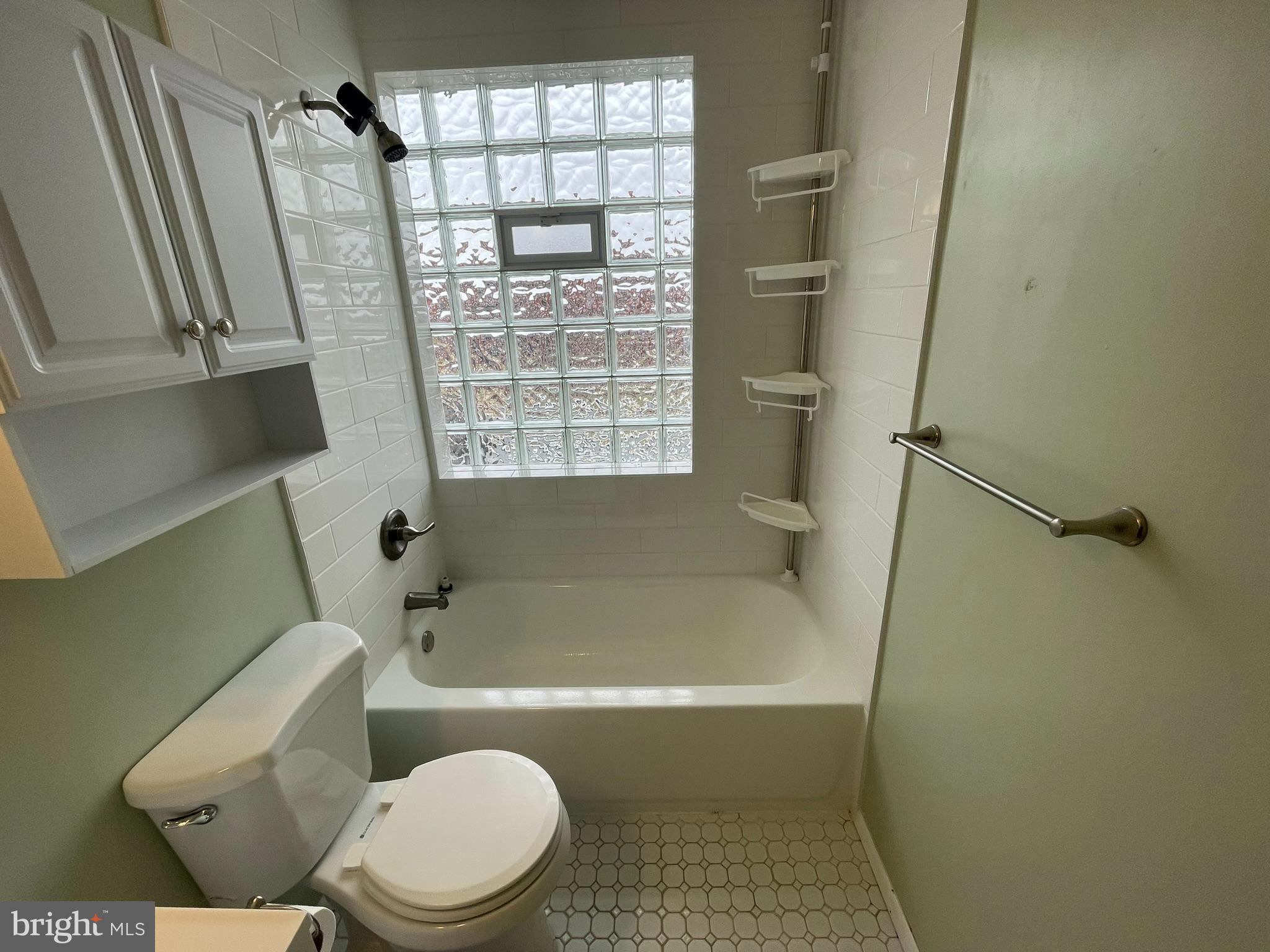 8134 Gray Haven Road Baltimore, MD 21222 - Photo 14 of 30 a bath room with a toilet a bath tub and a shower