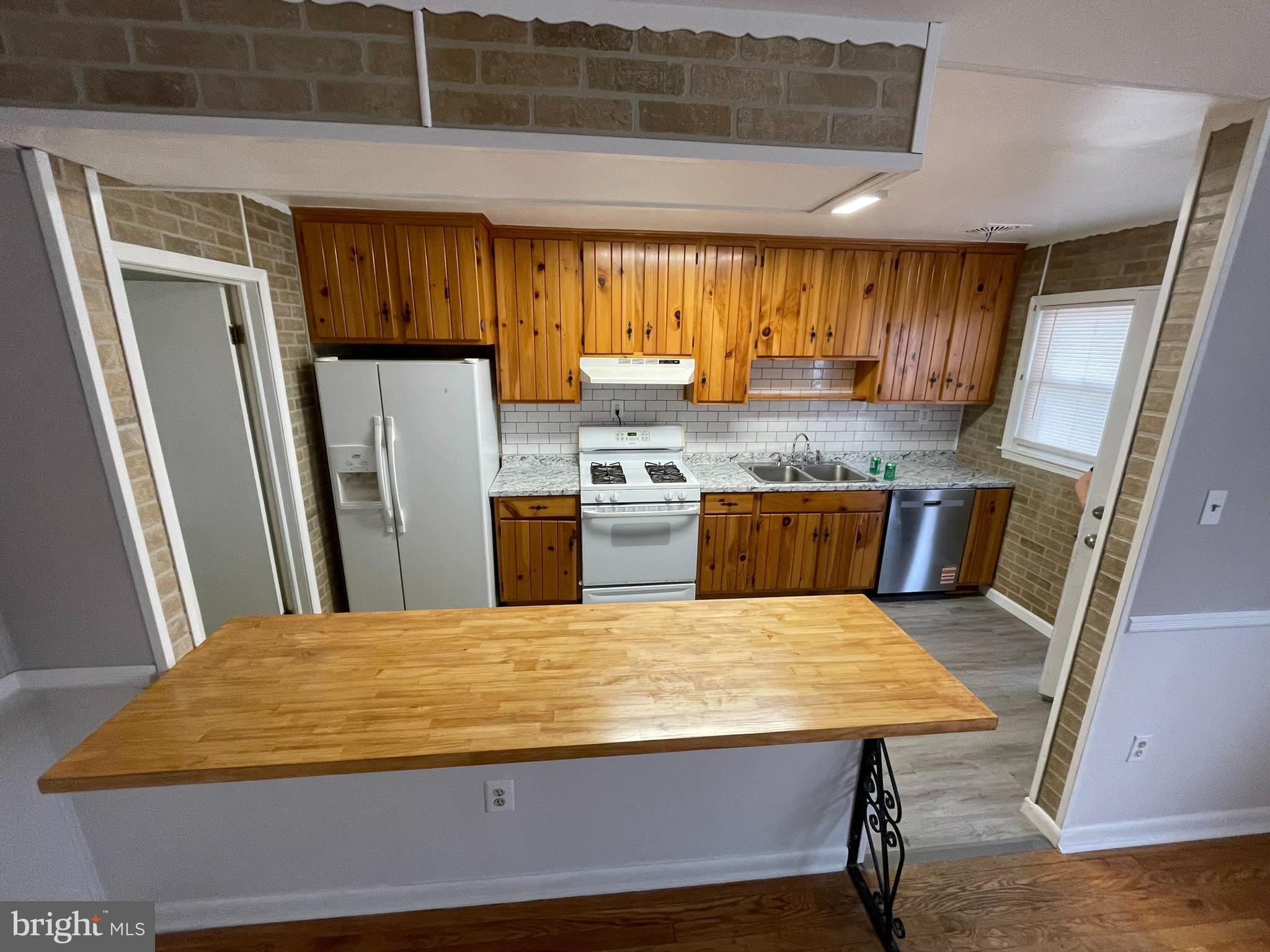 8134 Gray Haven Road Baltimore, MD 21222 - Photo 25 of 30 a kitchen with kitchen island a stove and a refrigerator