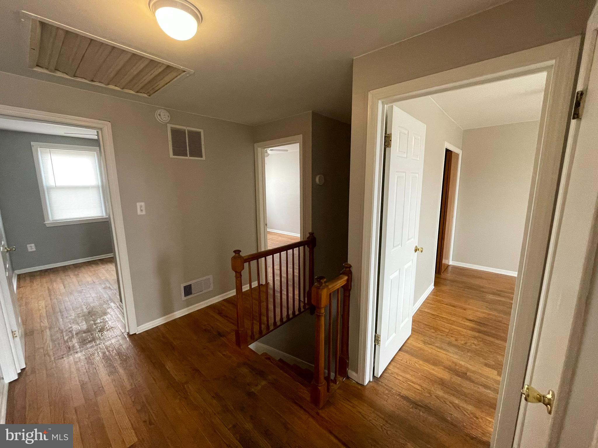 8134 Gray Haven Road Baltimore, MD 21222 - Photo 6 of 30 a view of a hallway with wooden floor and stairs
