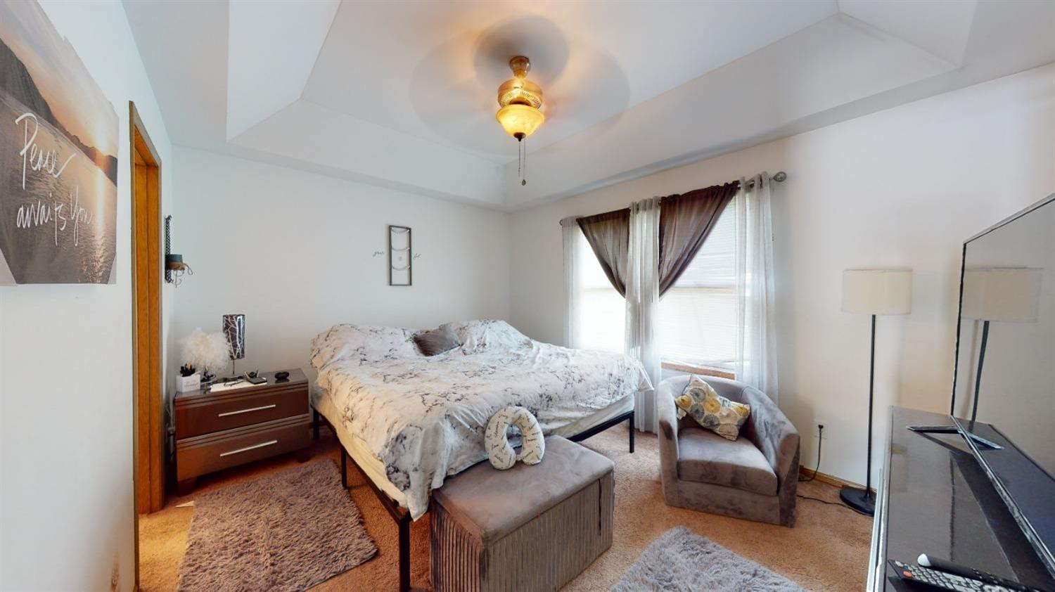 8602 Harrison Street Merrillville, IN 46410 - Photo 10 of 18 a bedroom that has a bed and a chandelier