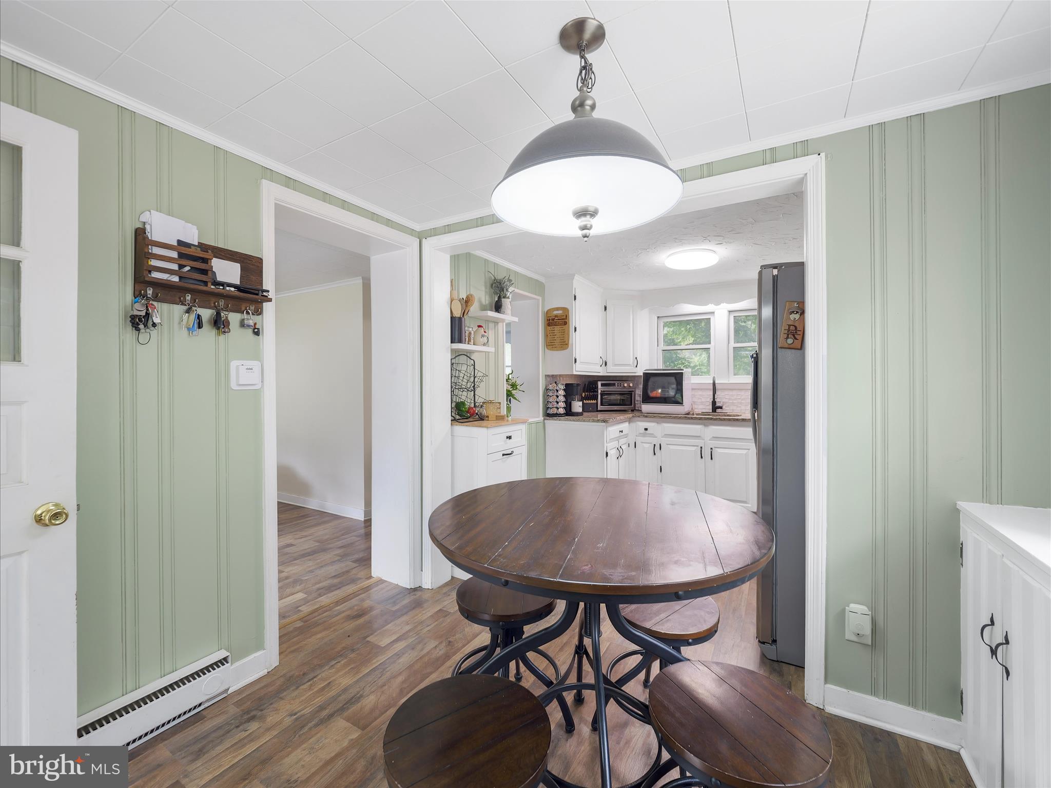 2550 Iron Springs Road Fairfield, PA 17320 - Photo 11 of 32 a kitchen with stainless steel appliances a dining table chairs and wooden floor