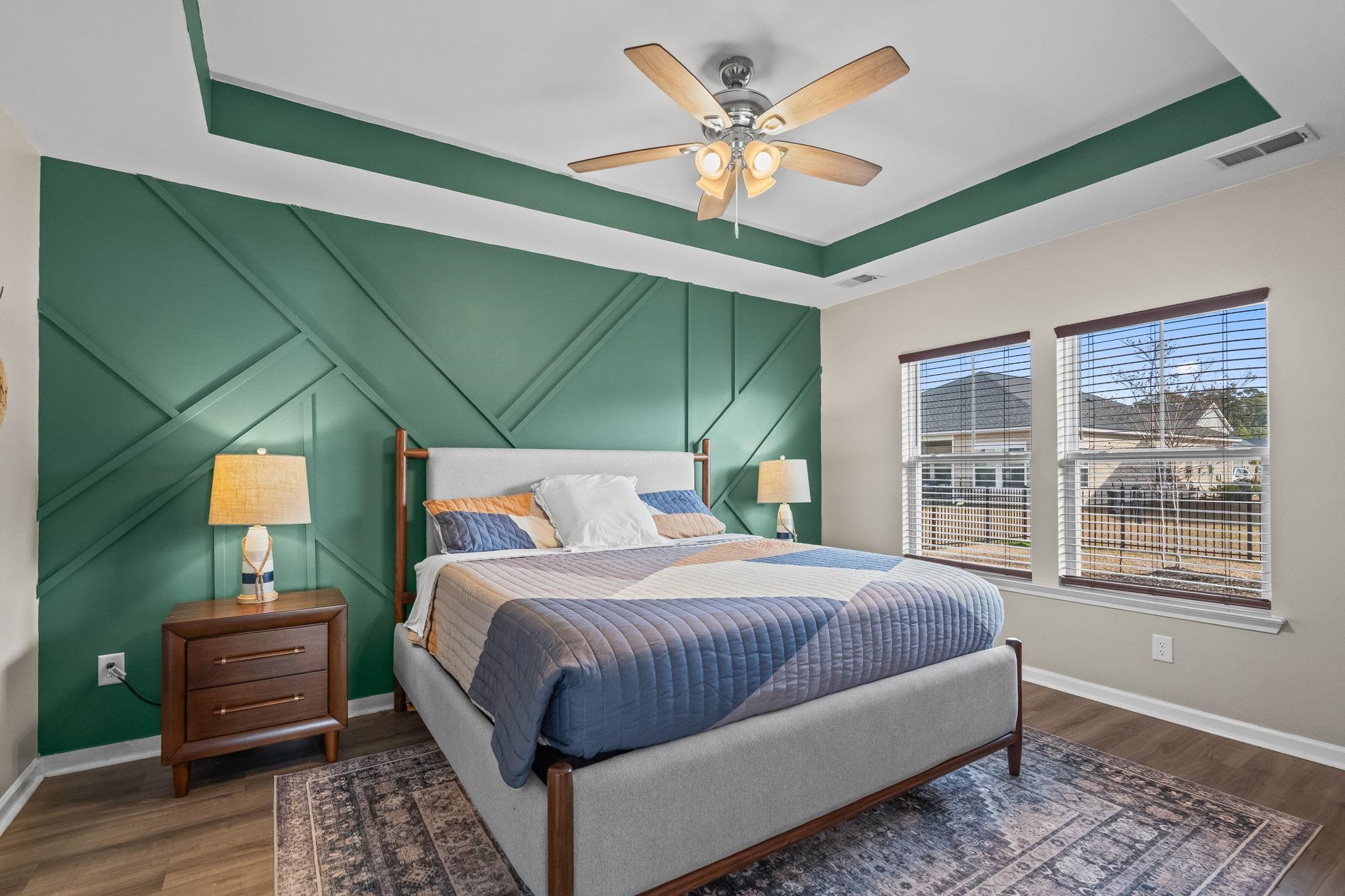 201 Craigflower Court Longs, SC 29568 - Photo 14 of 35 Bedroom with a decorative wall, a raised ceiling, ceiling fan, and dark wood-style flooring