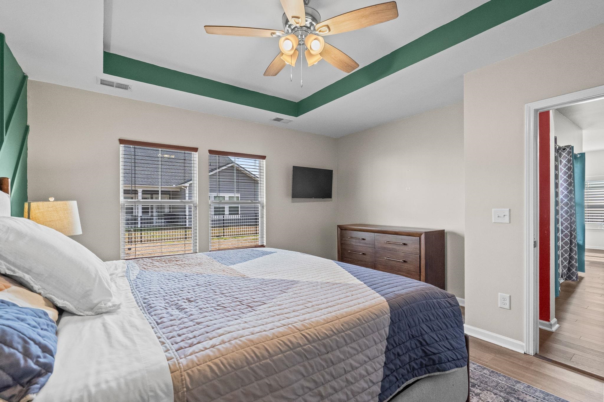 201 Craigflower Court Longs, SC 29568 - Photo 15 of 35 Bedroom with a raised ceiling, wood finished floors, and ceiling fan