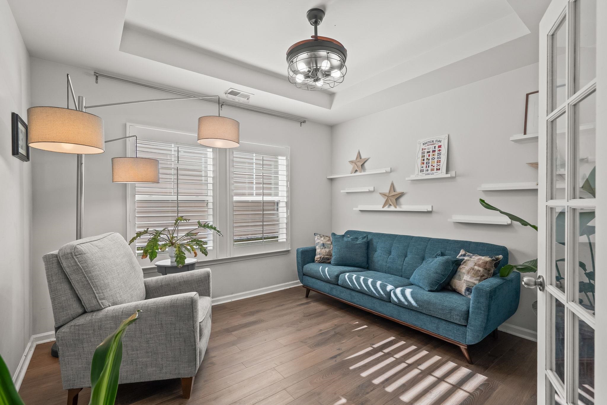 201 Craigflower Court Longs, SC 29568 - Photo 18 of 35 Living area featuring dark wood finished floors, a chandelier, and a raised ceiling