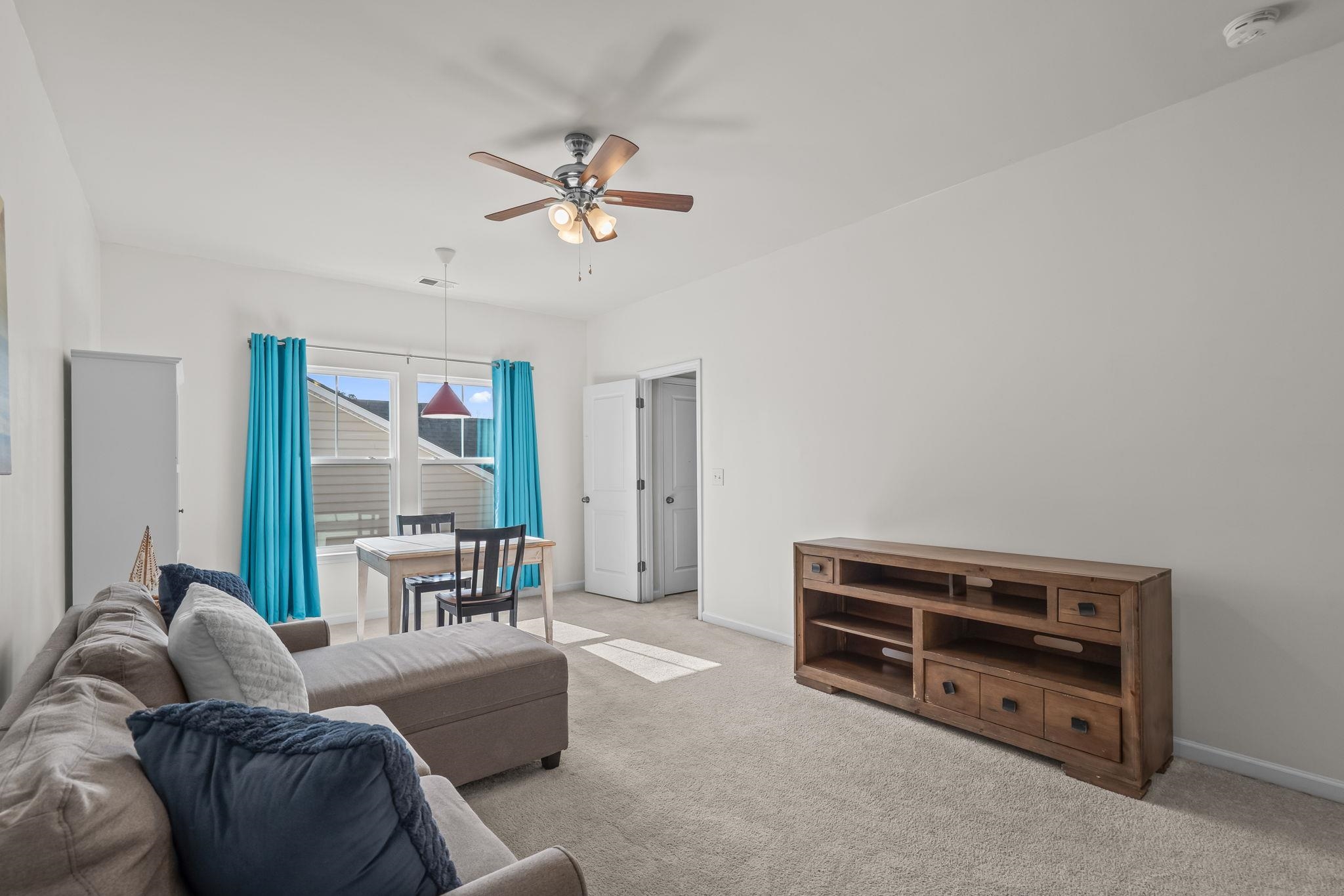 201 Craigflower Court Longs, SC 29568 - Photo 24 of 35 Carpeted living area featuring a ceiling fan and baseboards