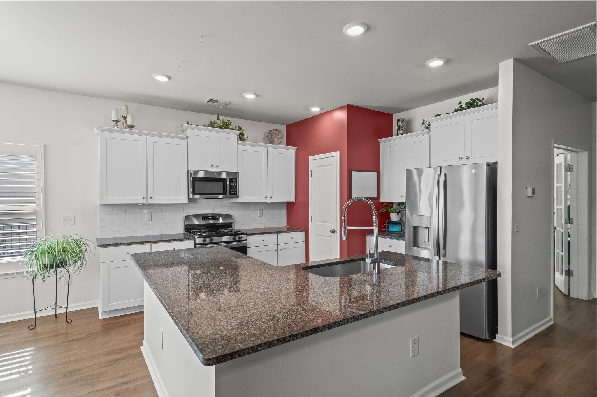 201 Craigflower Court Longs, SC 29568 - Photo 7 of 35 Kitchen with appliances with stainless steel finishes, dark stone countertops, white cabinets, a kitchen island with sink, and recessed lighting