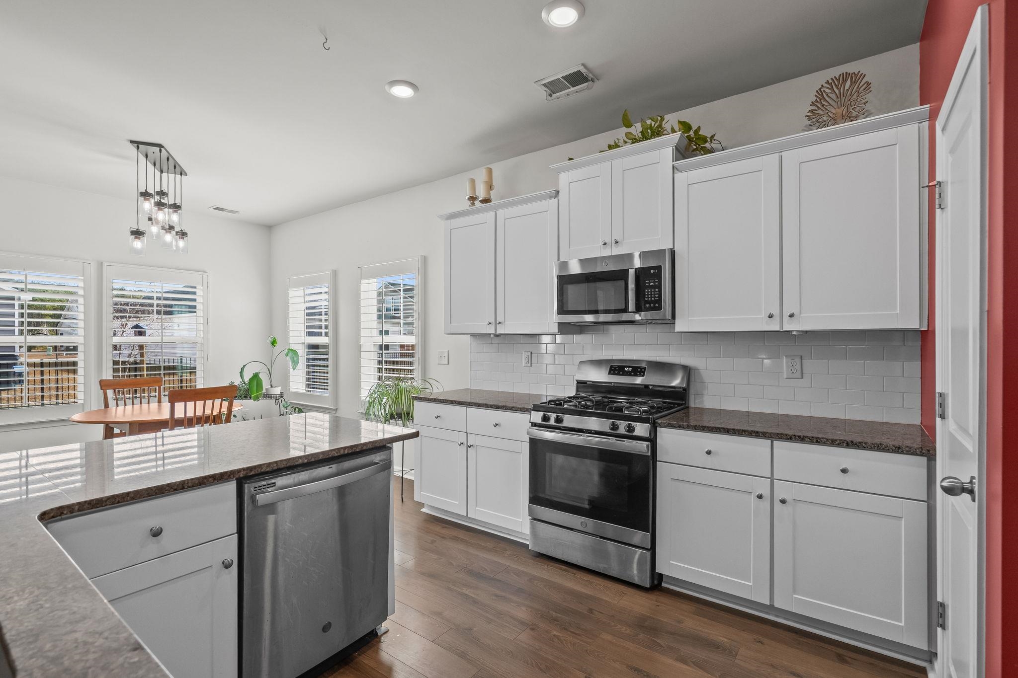 201 Craigflower Court Longs, SC 29568 - Photo 8 of 35 Kitchen with white cabinetry, stainless steel appliances, dark stone counters, hanging light fixtures, and recessed lighting