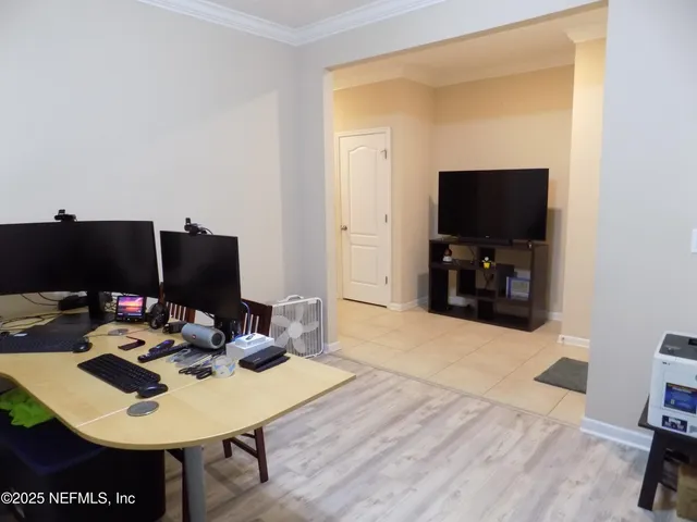 a kitchen with kitchen island granite countertop wooden cabinets and a refrigerator