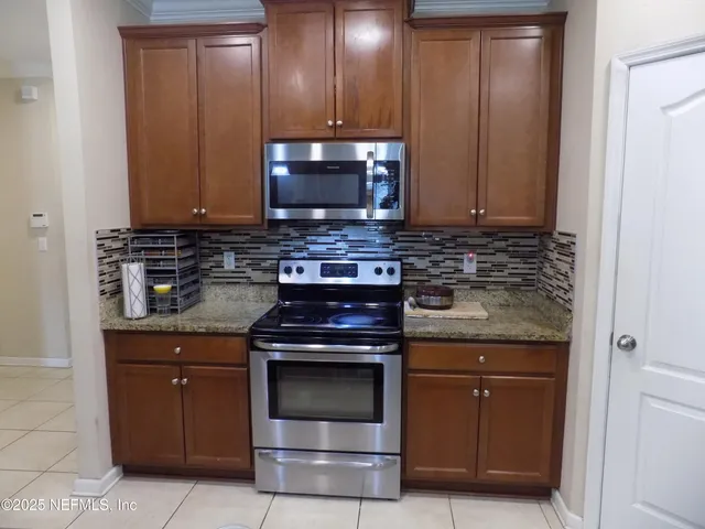 a kitchen with a refrigerator and cabinets