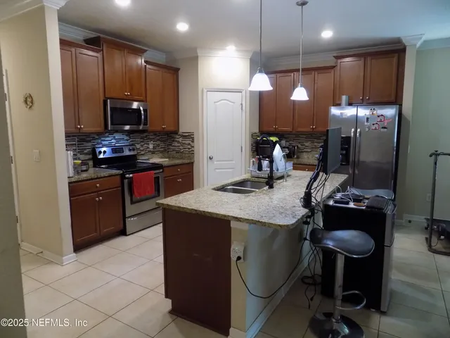 a kitchen with a refrigerator and cabinets