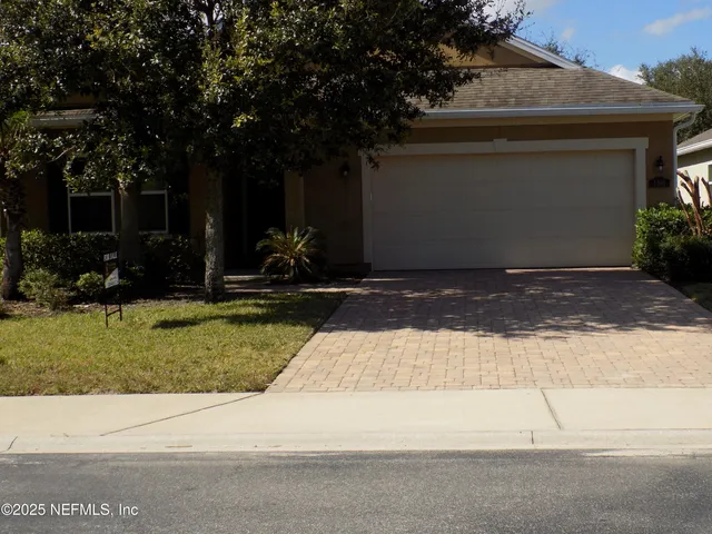 a view of a backyard with a tree