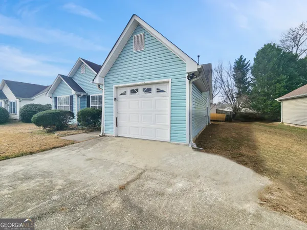 a view of a house with a yard and garage