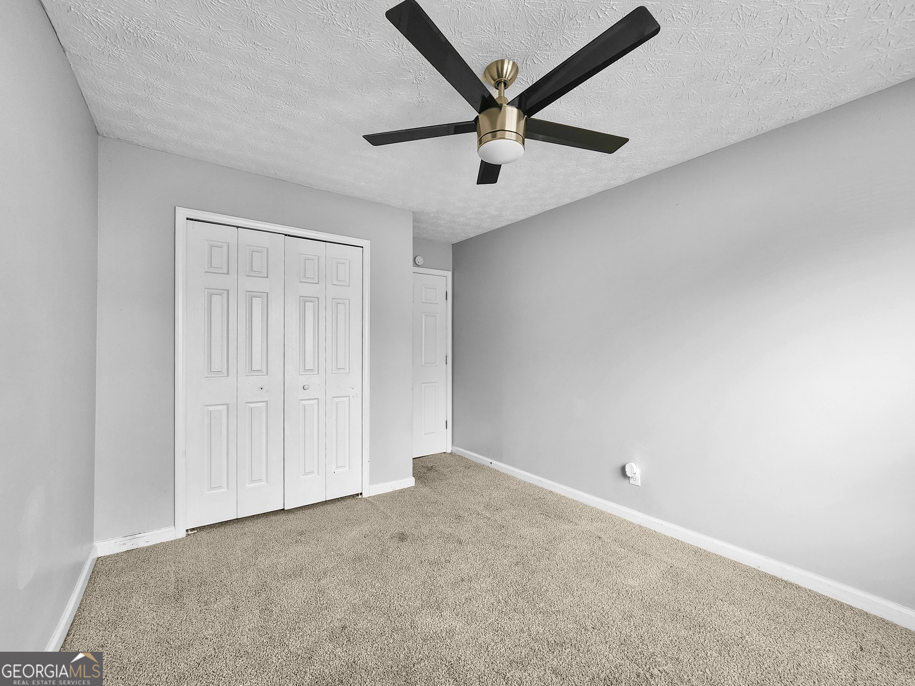 5855 Creekside Drive Rex, GA 30273 - Photo 12 of 18 an empty room with a ceiling fan and window