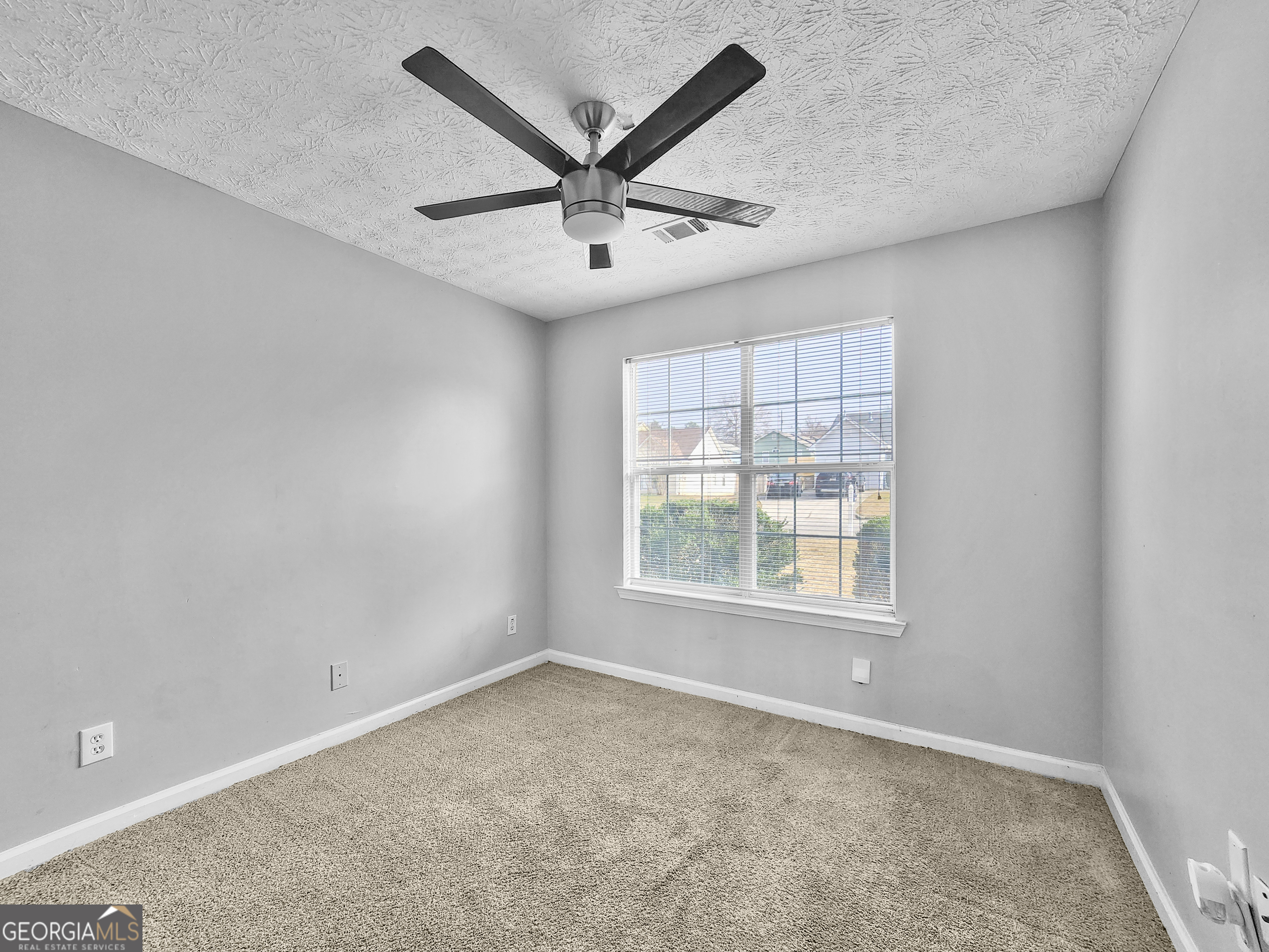 5855 Creekside Drive Rex, GA 30273 - Photo 14 of 18 an empty room with ceiling fan and windows