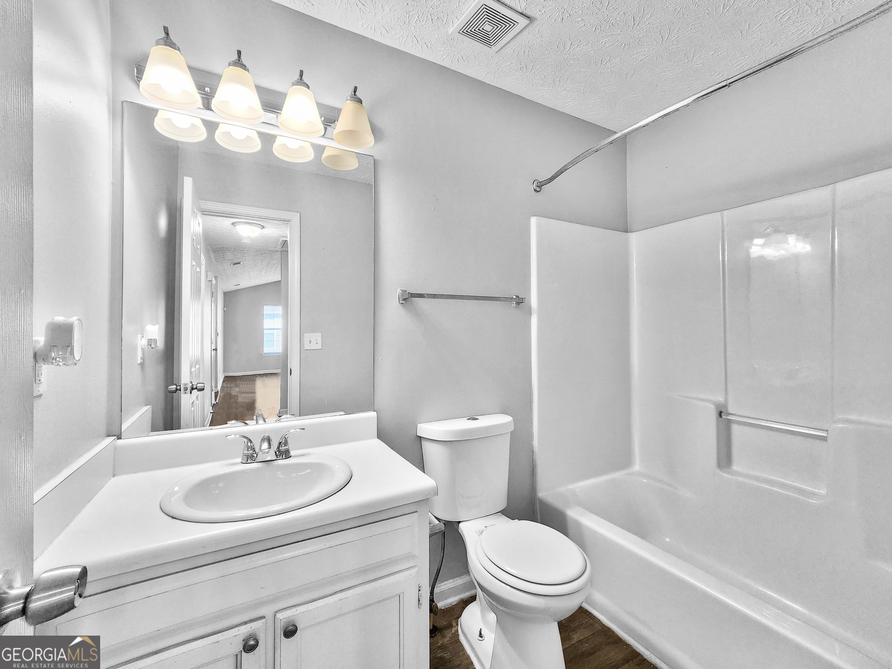 5855 Creekside Drive Rex, GA 30273 - Photo 15 of 18 a bathroom with a sink toilet and shower