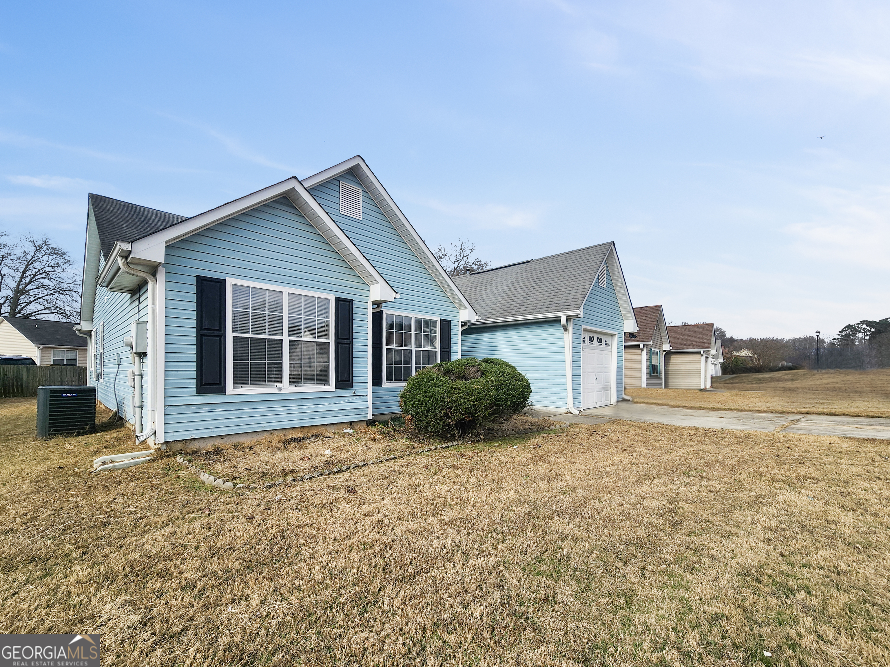 5855 Creekside Drive Rex, GA 30273 - Photo 3 of 18 a front view of a house with a yard and garage