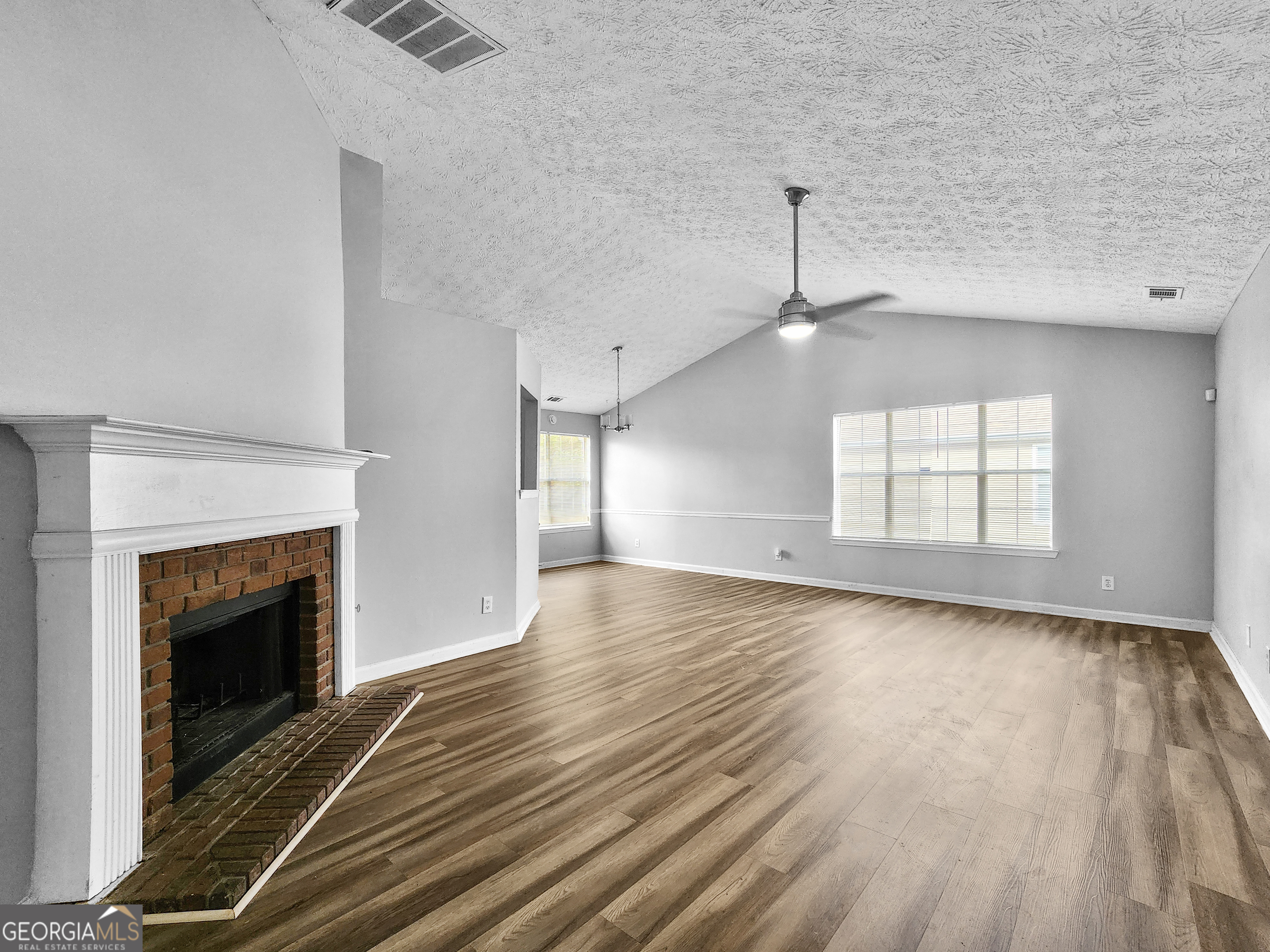 5855 Creekside Drive Rex, GA 30273 - Photo 4 of 18 a view of empty room with wooden floor and fireplace