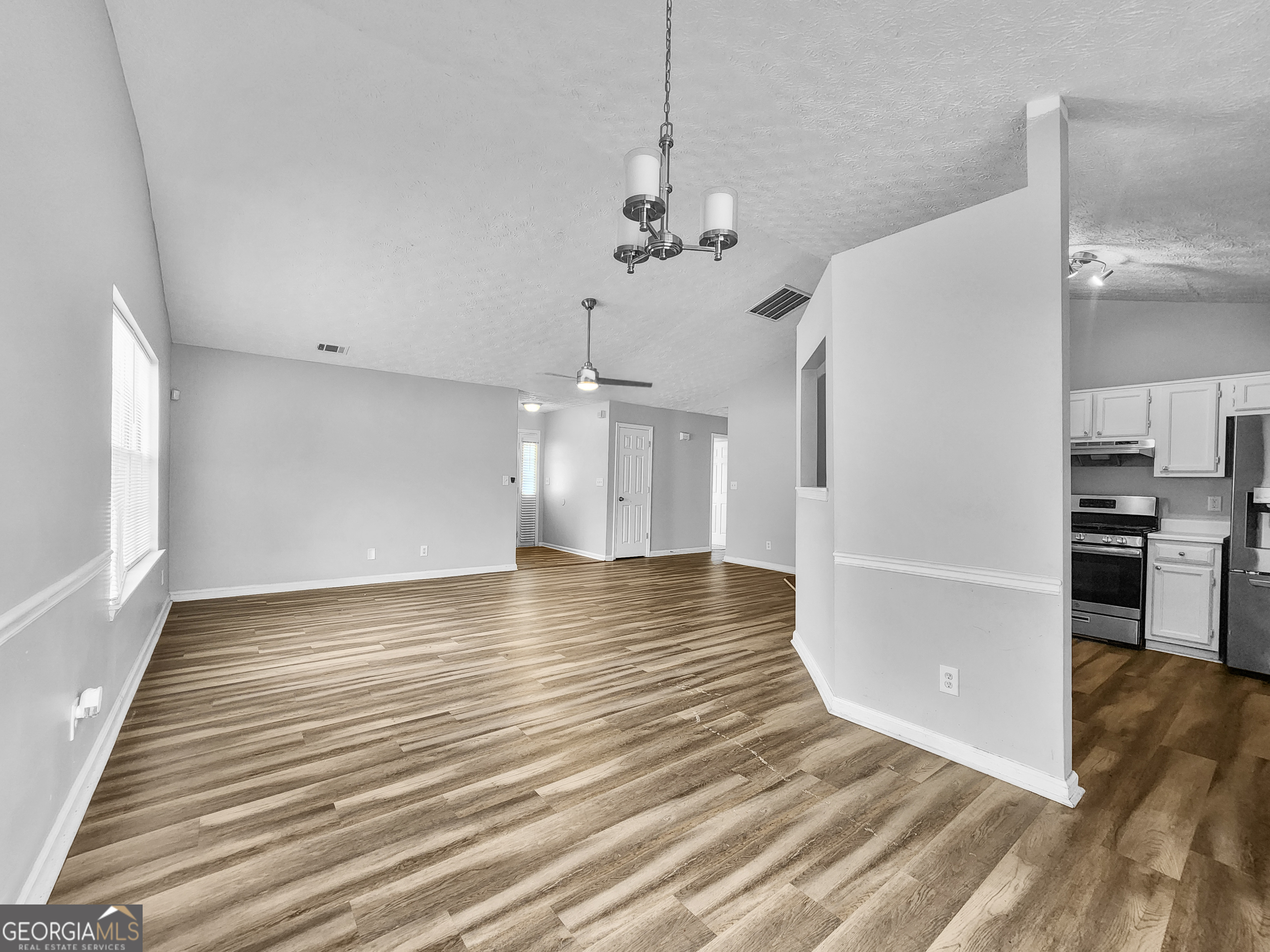 5855 Creekside Drive Rex, GA 30273 - Photo 5 of 18 a view of a kitchen with a sink and dishwasher a refrigerator with wooden floor