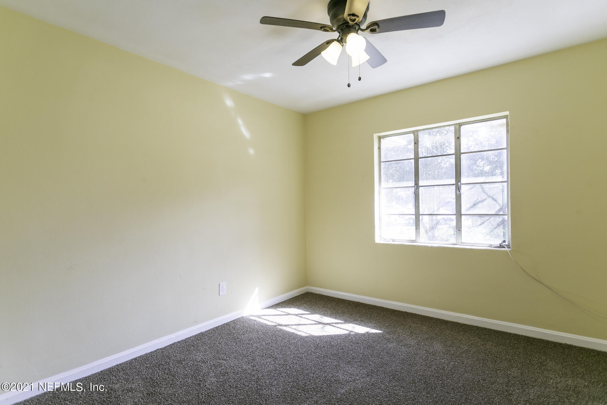 3921 St Augustine Road Jacksonville, FL 32207 - Photo 13 of 35 an empty room with a window and a fan