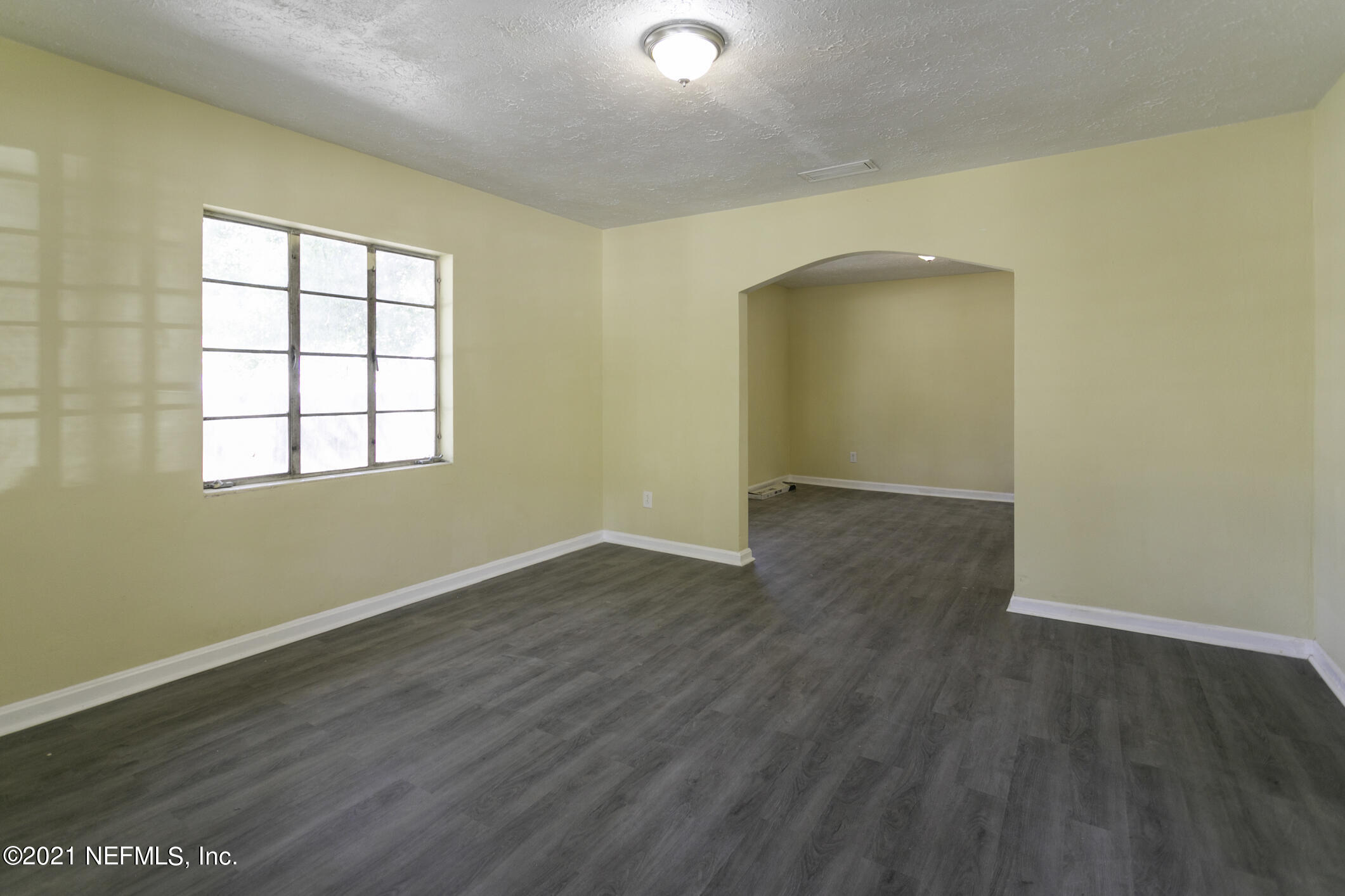 3921 St Augustine Road Jacksonville, FL 32207 - Photo 9 of 35 an empty room with wooden floor and windows