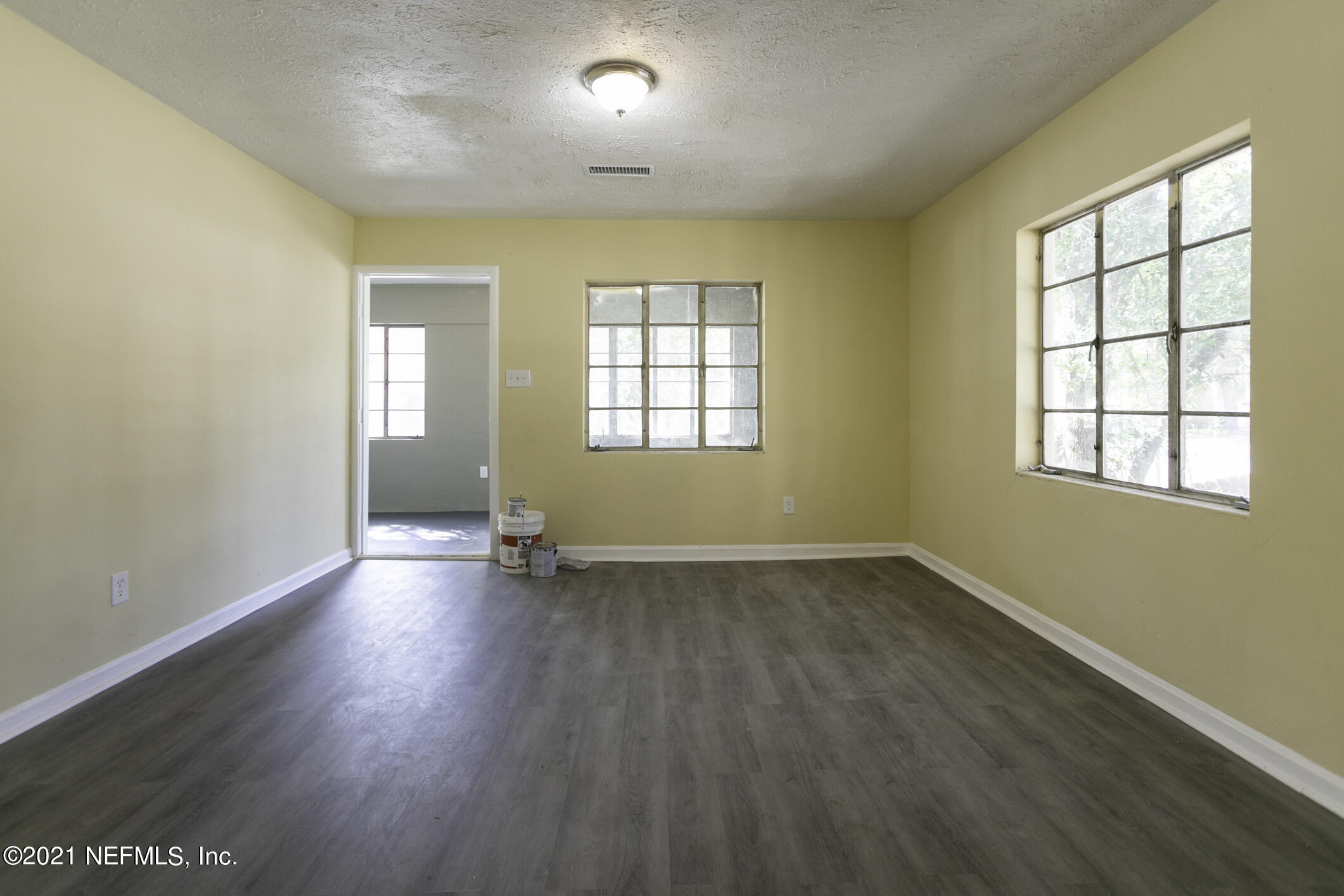3921 St Augustine Road Jacksonville, FL 32207 - Photo 10 of 35 an empty room with wooden floor and windows