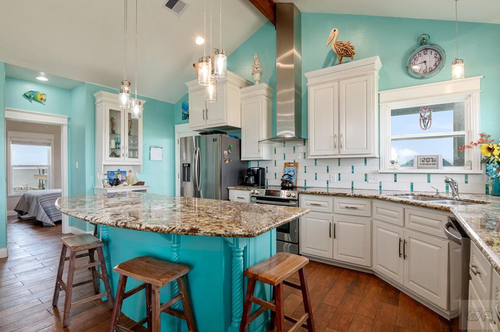 1024 Mae Street Port Bolivar, TX 77650 - Photo 13 of 27 a kitchen with cabinets and chairs