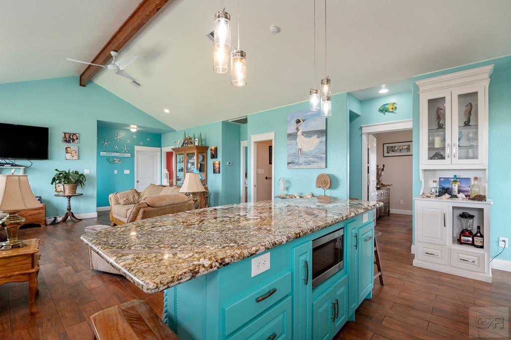 1024 Mae Street Port Bolivar, TX 77650 - Photo 14 of 27 a living room with kitchen island granite countertop furniture and a flat screen tv
