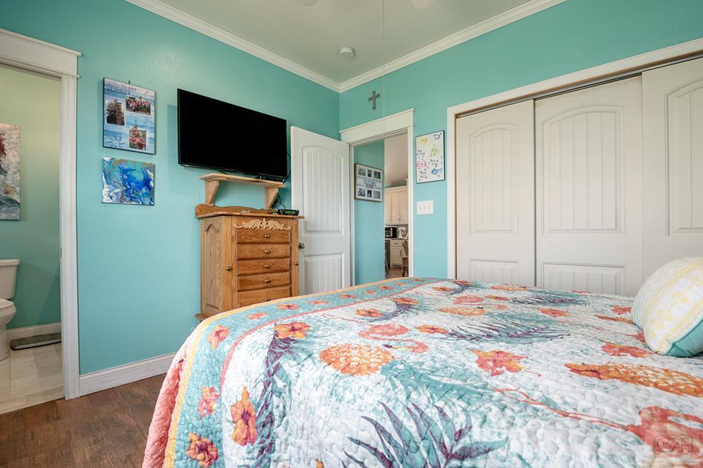 1024 Mae Street Port Bolivar, TX 77650 - Photo 16 of 27 a bedroom with a bed and a flat screen tv
