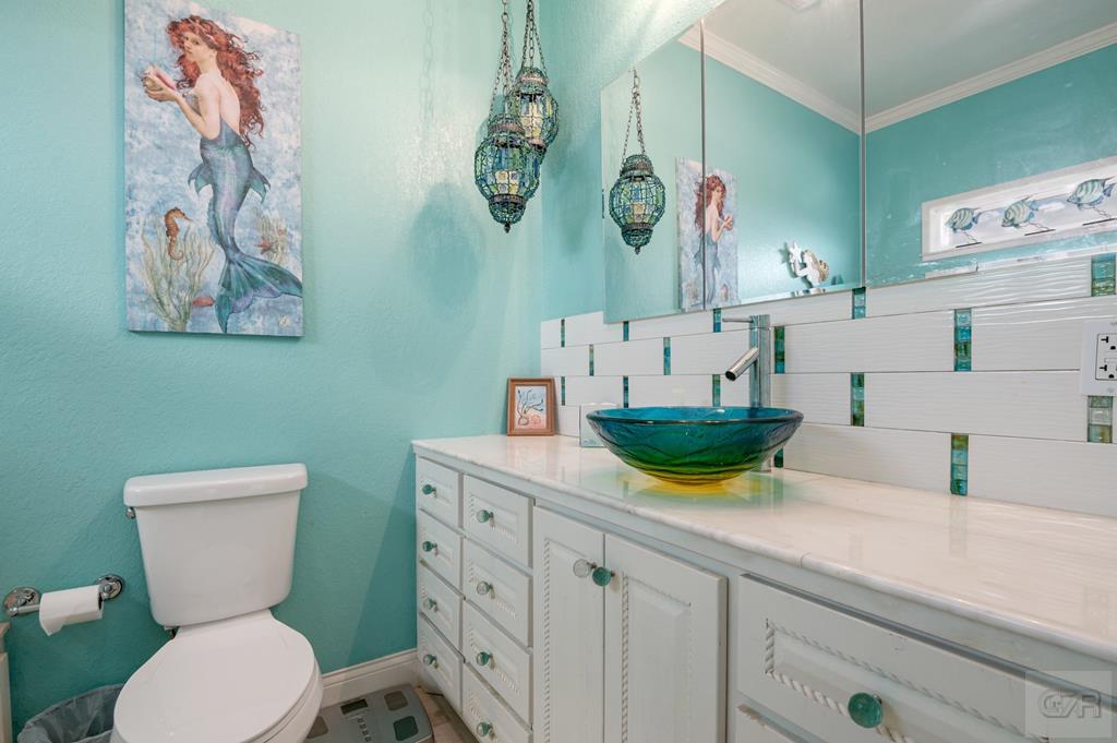 1024 Mae Street Port Bolivar, TX 77650 - Photo 17 of 27 a bathroom with a sink a mirror and toilet