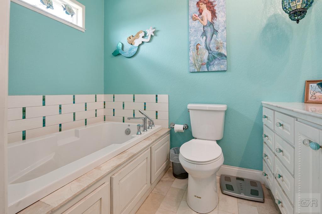 1024 Mae Street Port Bolivar, TX 77650 - Photo 18 of 27 a bathroom with a sink a toilet and a bathtub