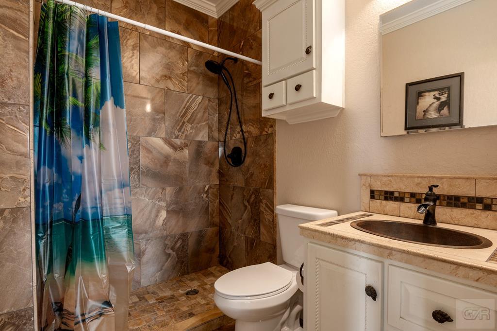 1024 Mae Street Port Bolivar, TX 77650 - Photo 20 of 27 a bathroom with a sink toilet and shower