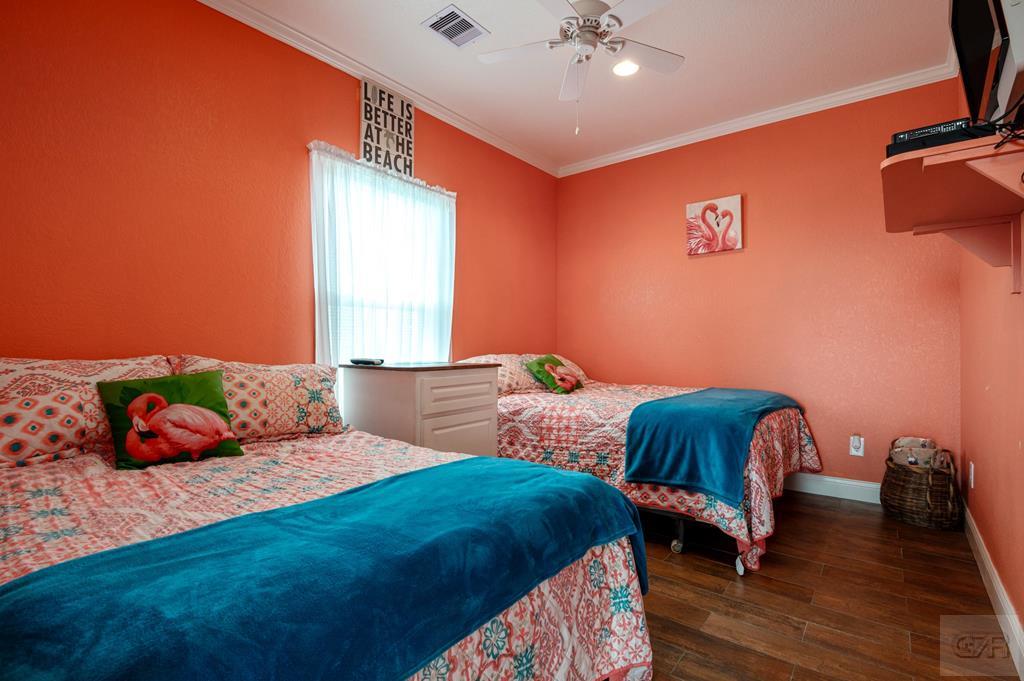 1024 Mae Street Port Bolivar, TX 77650 - Photo 21 of 27 a bedroom with two beds and wooden floor