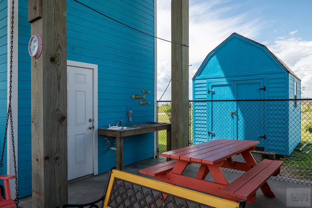 1024 Mae Street Port Bolivar, TX 77650 - Photo 24 of 27 a backyard of a house with barbeque oven table and chairs