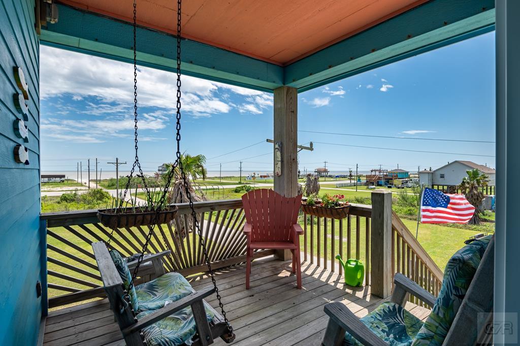 1024 Mae Street Port Bolivar, TX 77650 - Photo 5 of 27 a balcony with furniture and a floor to ceiling window
