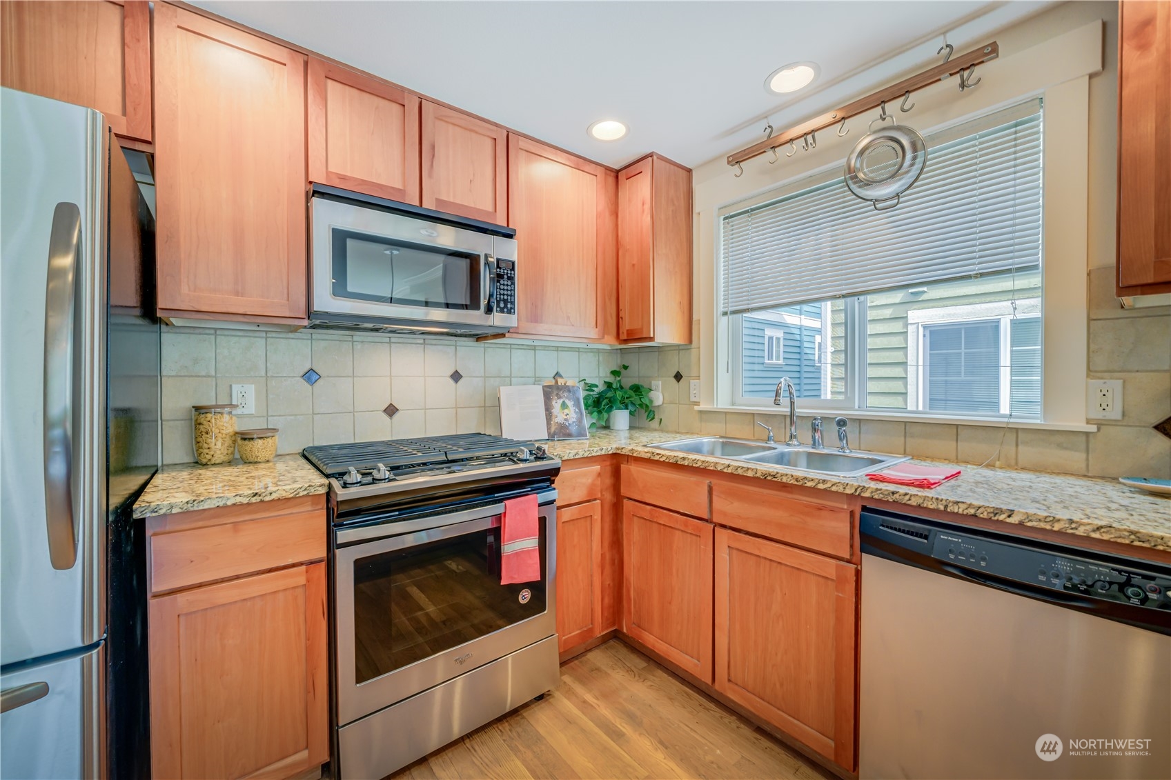 508 North 46th Street, Unit B Seattle, WA 98103 - Photo 12 of 30 a kitchen with stainless steel appliances granite countertop a sink and a stove