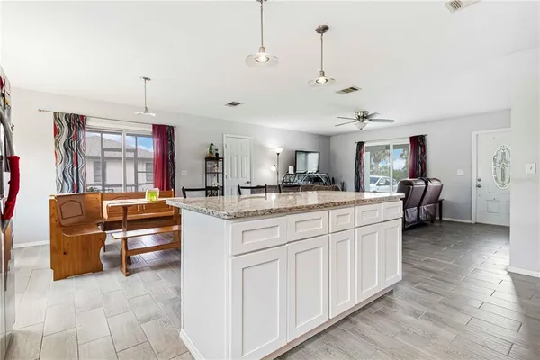 a kitchen with stainless steel appliances kitchen island granite countertop a sink and cabinets