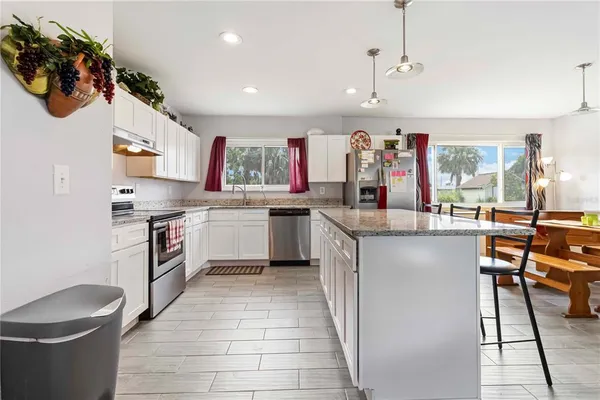 a kitchen with a sink refrigerator and cabinets