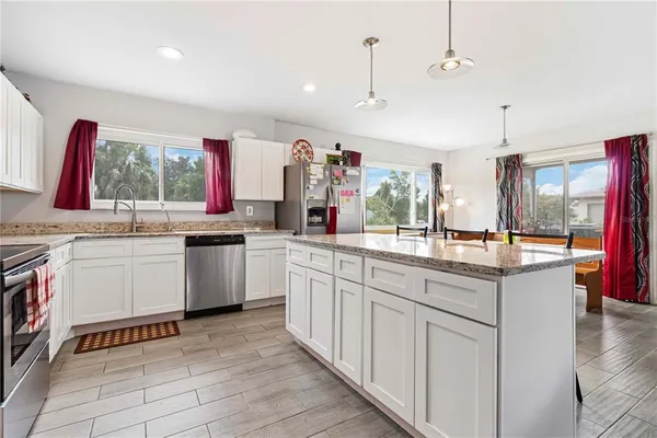 a kitchen with stainless steel appliances kitchen island granite countertop a sink and cabinets