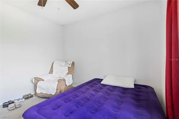 a bedroom with a bed and a couch