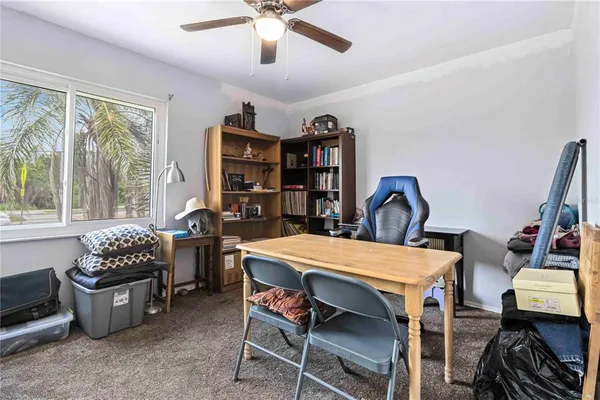 a dining room with furniture and a floor to ceiling window